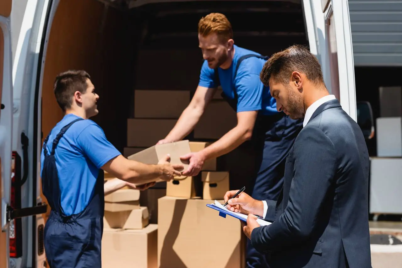 Movers carefully wrapping fragile items for transport in Pensacola, FL