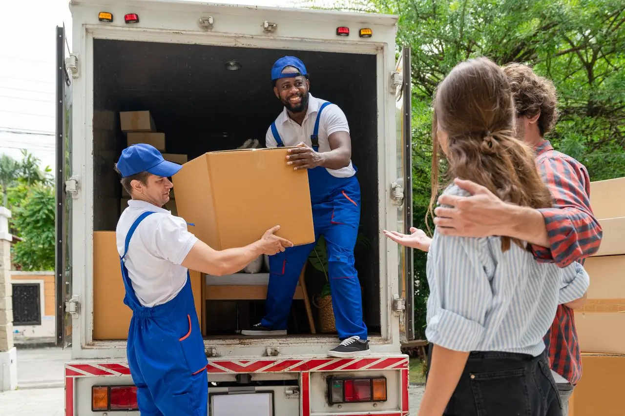 Professional movers loading cardboard boxes into moving truck in Charleston, WV