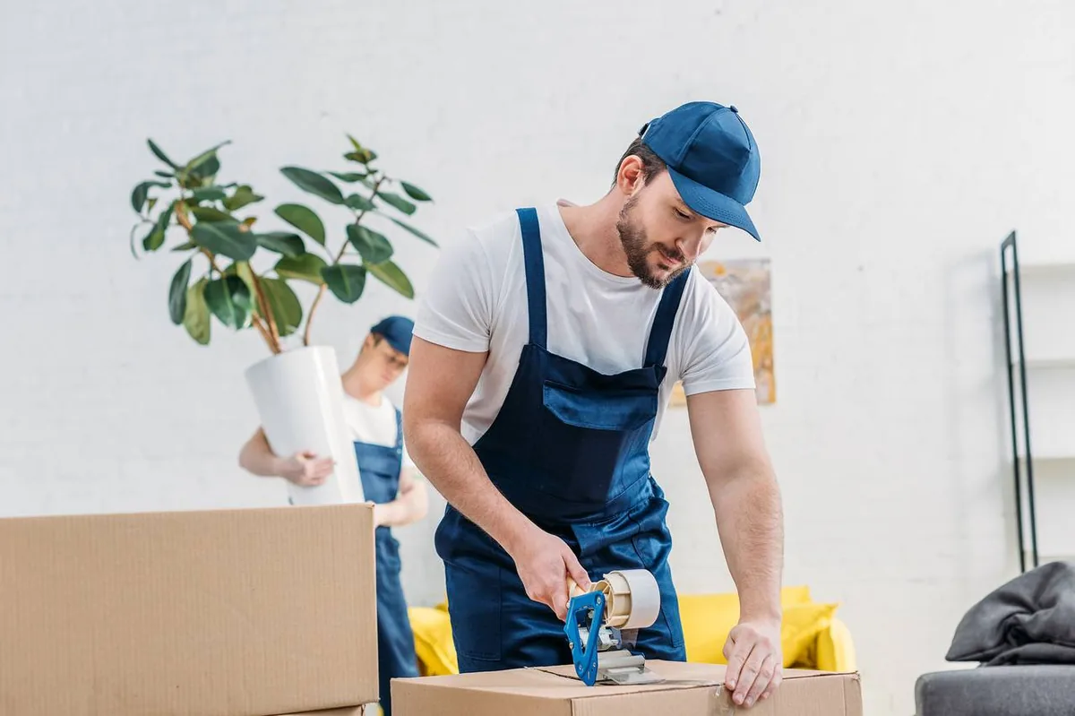 Professional movers packing boxes for interstate move