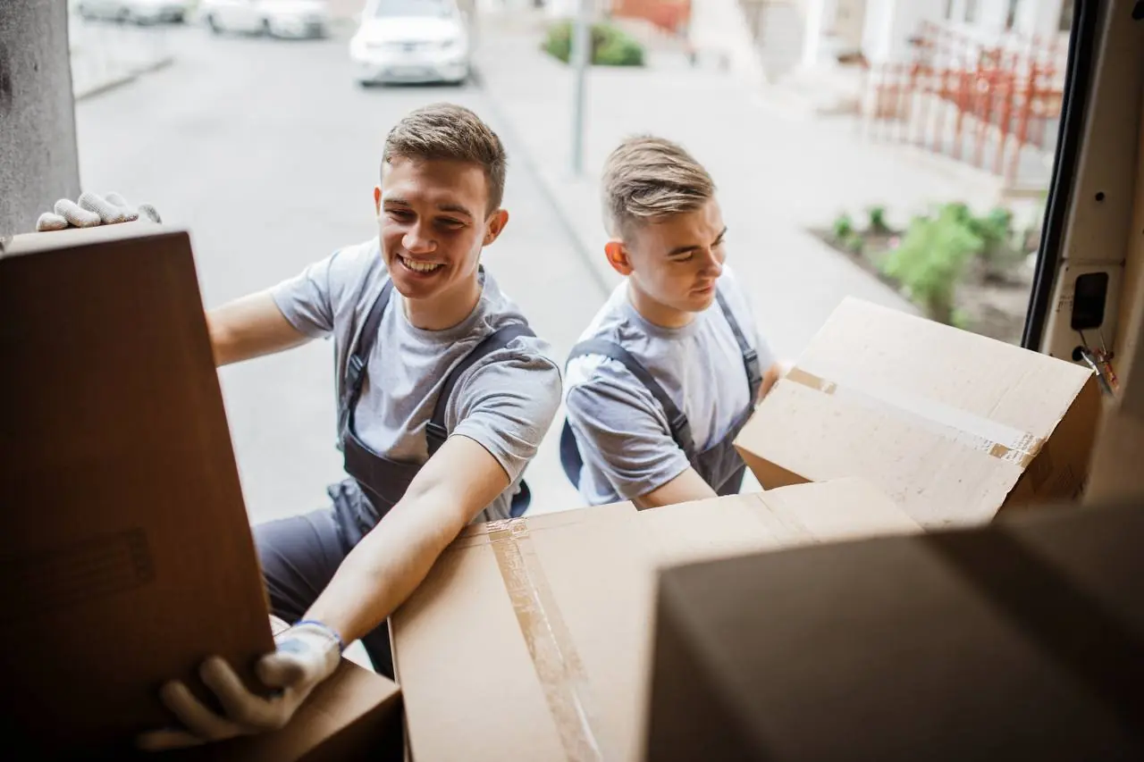 Professional movers wrapping sofa for long distance transport in Springfield, MO